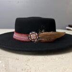 Ronald Joseph Kerr Black hat with ribbon, beadwork, and brown feather
