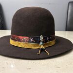 Ronald Joseph Kerr Dark Brown hat with ribbon, leather, and feather pendant
