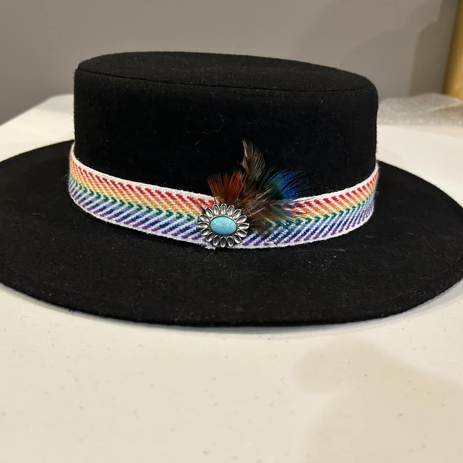 Ronald Joseph Kerr Side of black hat with ribbon, feathers and pendant