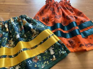 Desiree Sinicrope - Two Ribbon Skirts, One Orange one Green and yellow