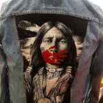Frances Pasap- Jean Jacket with an Indigenous man portrait and a red hand print on his mouth