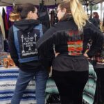 Frances Pasap- Two woman standing with jean a jean jacket and vest